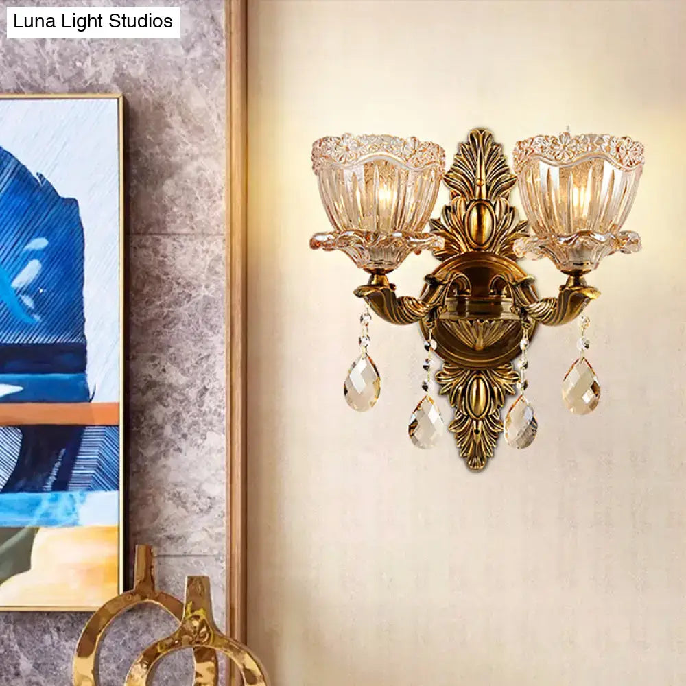 Modern floral brass wall sconce with teardrop crystal drop living room