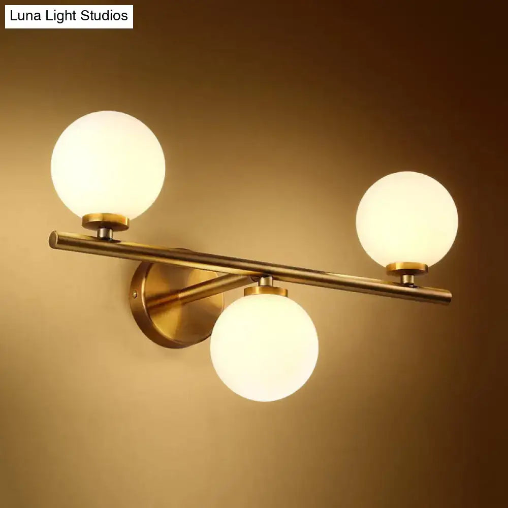 Modern gold 3-light wall sconce with white glass shades for bedroom