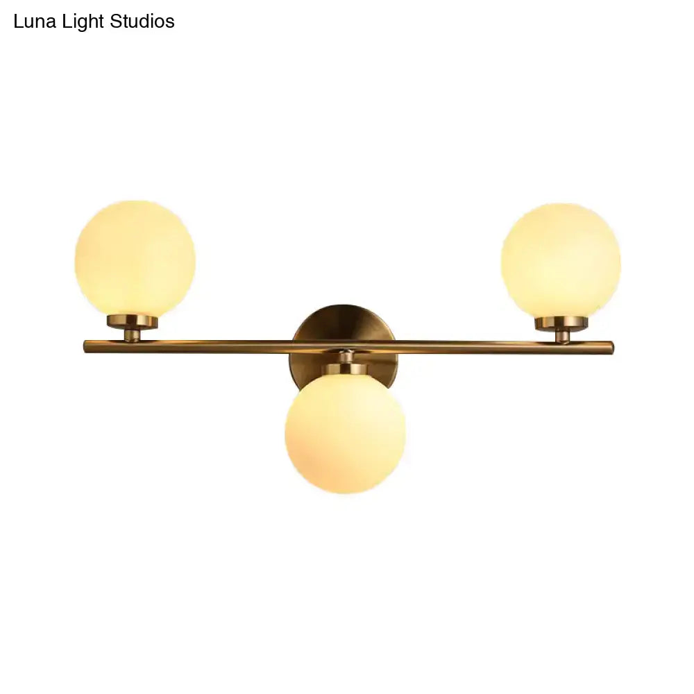 Modern gold 3-light wall sconce with white glass shades for bedroom