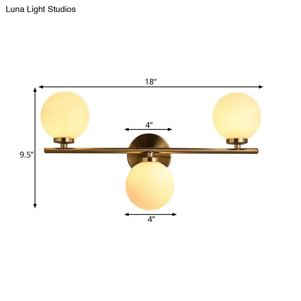 Modern gold 3-light wall sconce with white glass shades for bedroom