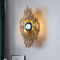 Modern gold agate deco living room wall sconce with radiating vertical bars and central glowing blue orb inch fixture