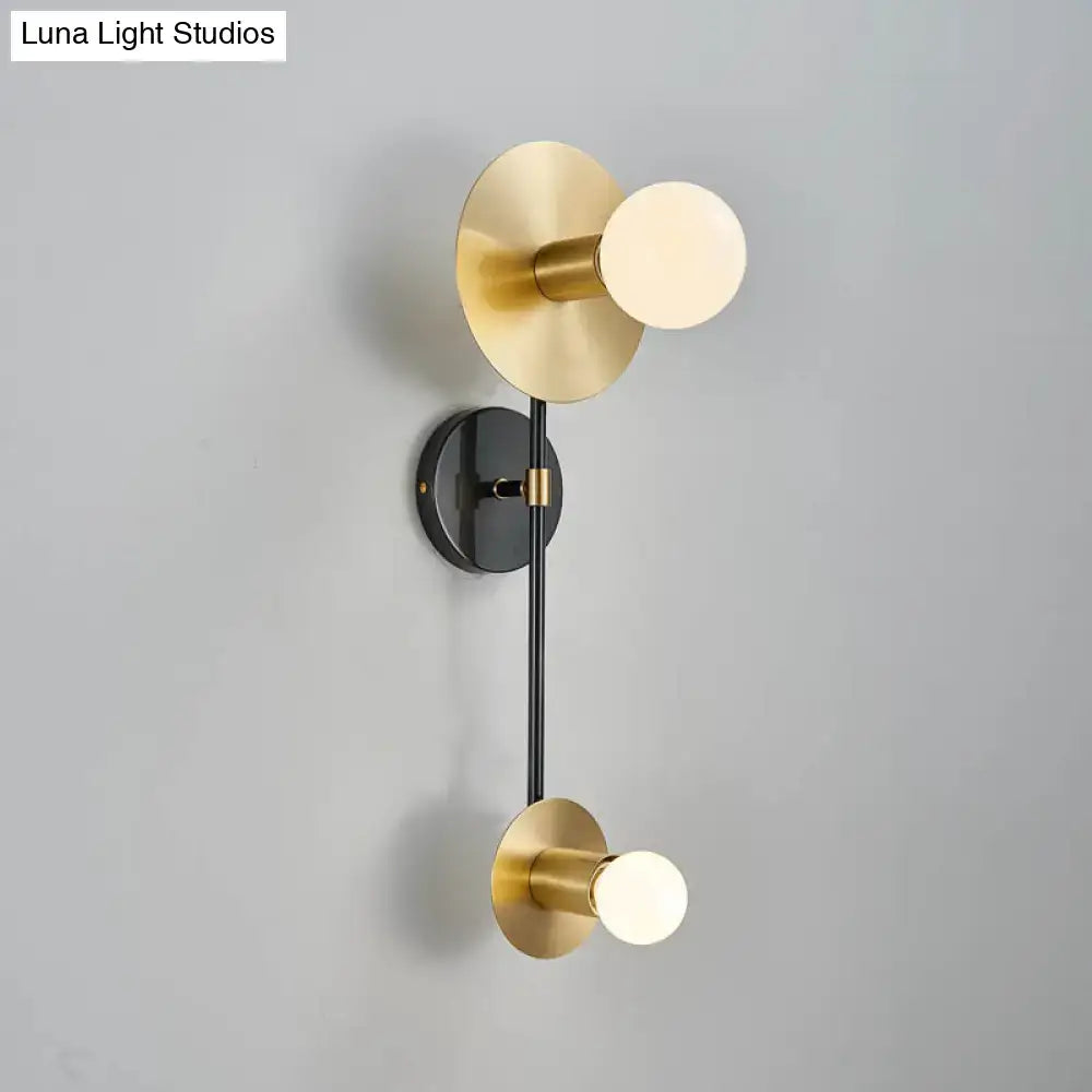 Modern gold and black wall sconce with opal glass shade bedroom light