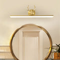 Modern gold and black antler vanity sconce light with a gold-toned deer head design and antlers for bedroom use