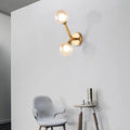 Gold-toned modern wall lamp with double globe glass bulbs designed as a corridor sconce light fixture