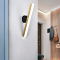 Modern gold and black led wall sconce with gold finish and sleek black base showcasing fixture width for living room use