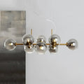Modern brass bar pendant light with six smoky glass globe bulbs in gold and black linear design fixture width for kitchen island