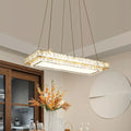 Rectangular crystal chandelier with clear crystal blocks and gold-toned accents for dining room and kitchen island