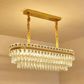 Gold-toned rectangular decorbites contemporary island light with cascading crystal droplets suitable for 110v-120v and 220v-240v