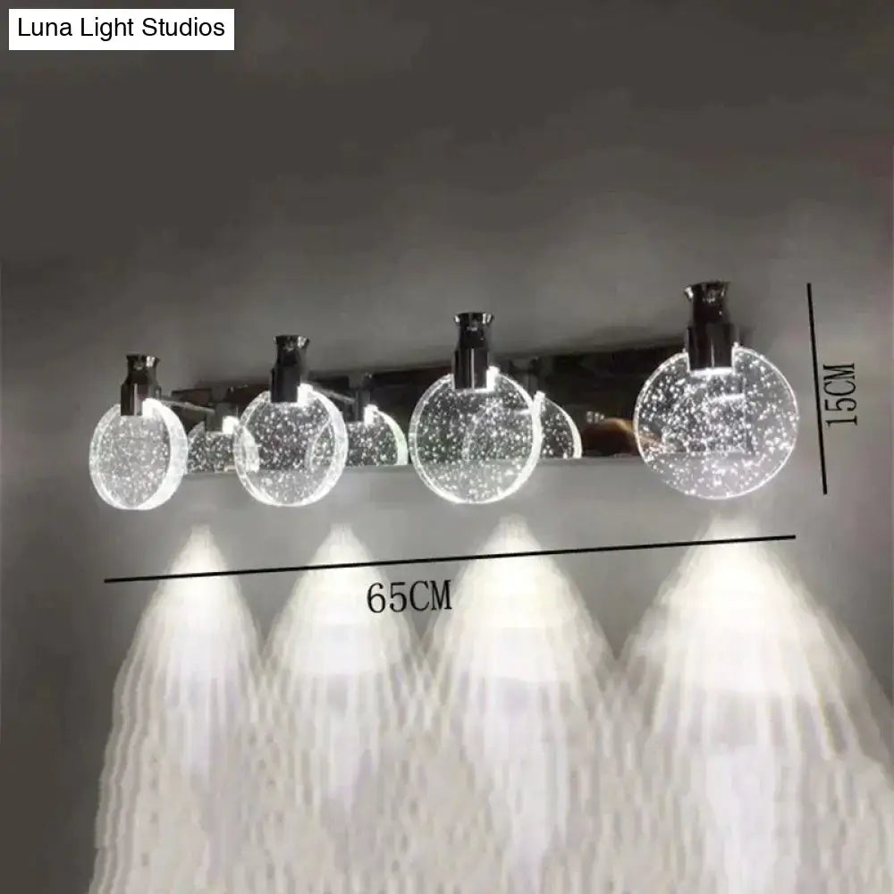 Modern gold crystal led wall lamp featuring three simple crystal led globes with sleek chrome accents and illumination