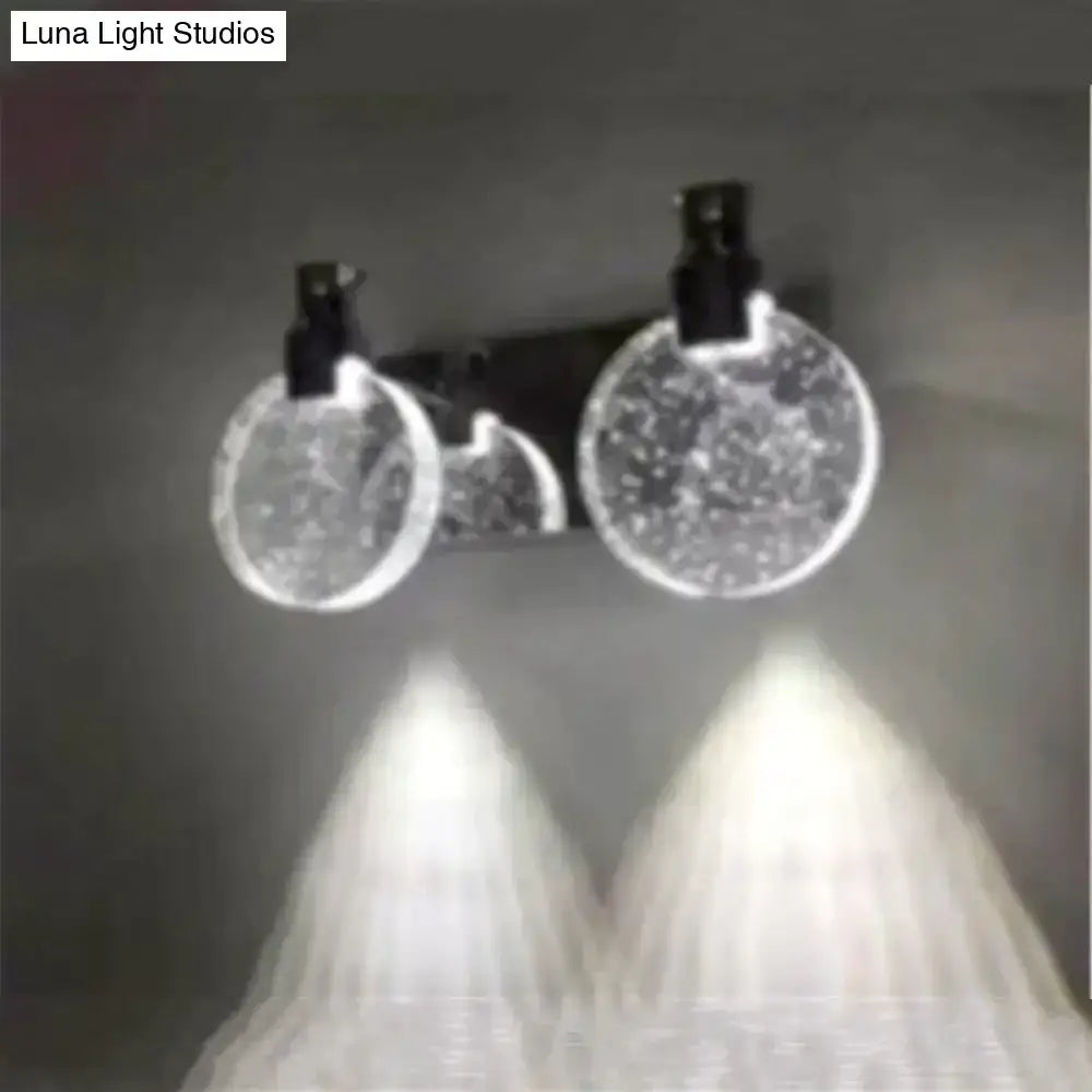 A modern gold crystal led wall lamp with three globe light and simple crystal led bubble glass diffusers in black fixtures