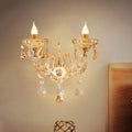 Modern gold crystal wall sconce with two candle-style bulbs and faceted glass ornaments inch fixture for bedroom