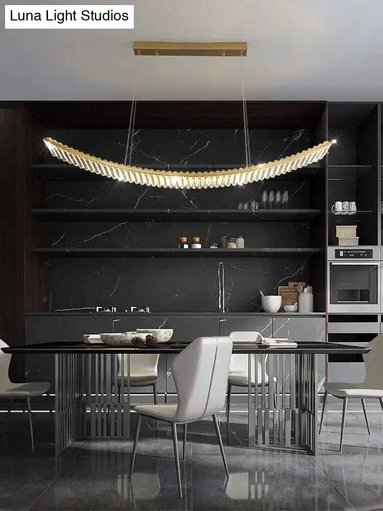 Modern gold curved crystal chandelier featuring warm led lighting as a suspended crystal chandelier for dining rooms