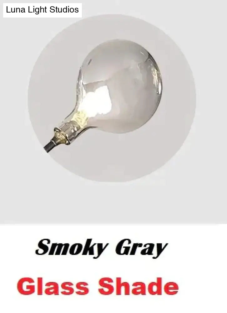 Smoky gray glass shade with frosted finish on modern gold firefly tree branch led wall light for bedroom use