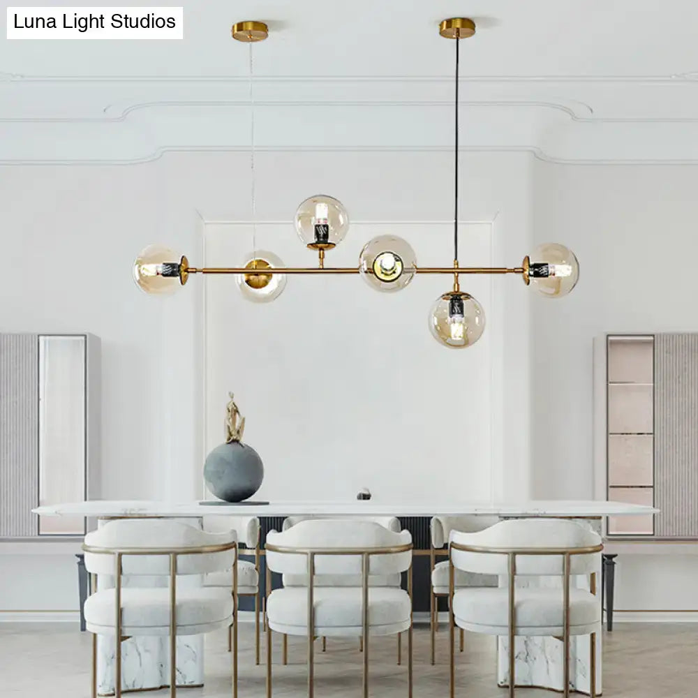 Modern gold island pendant light with glass globes for dining room