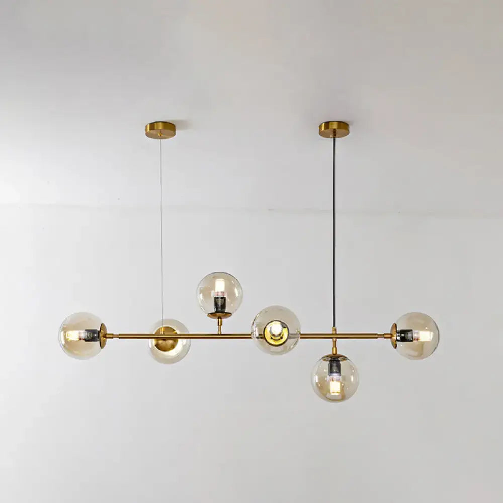 Modern gold island pendant light with glass globes for dining room