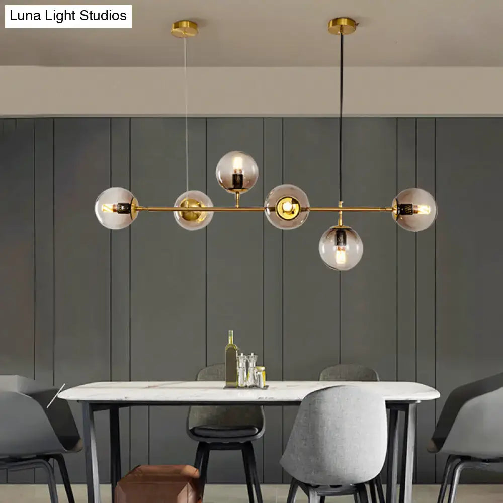 Modern gold island pendant light with glass globes for dining room