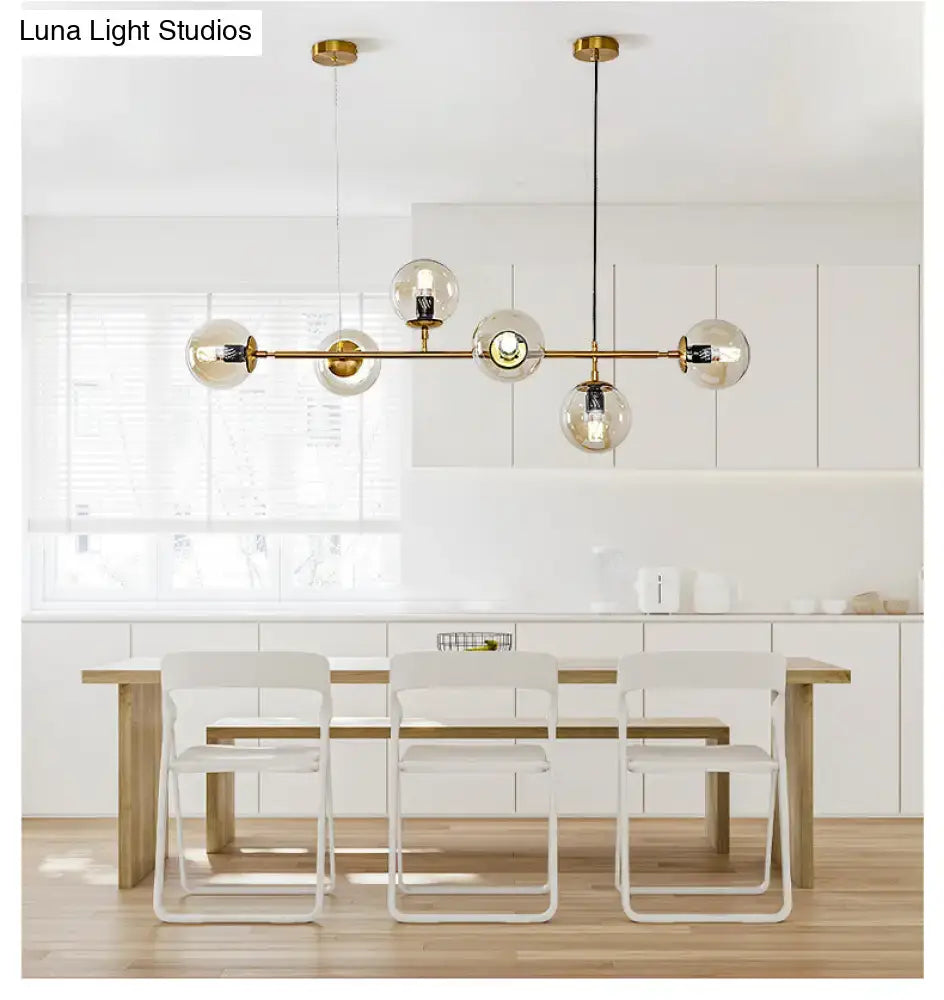 Modern gold island pendant light with glass globes for dining room