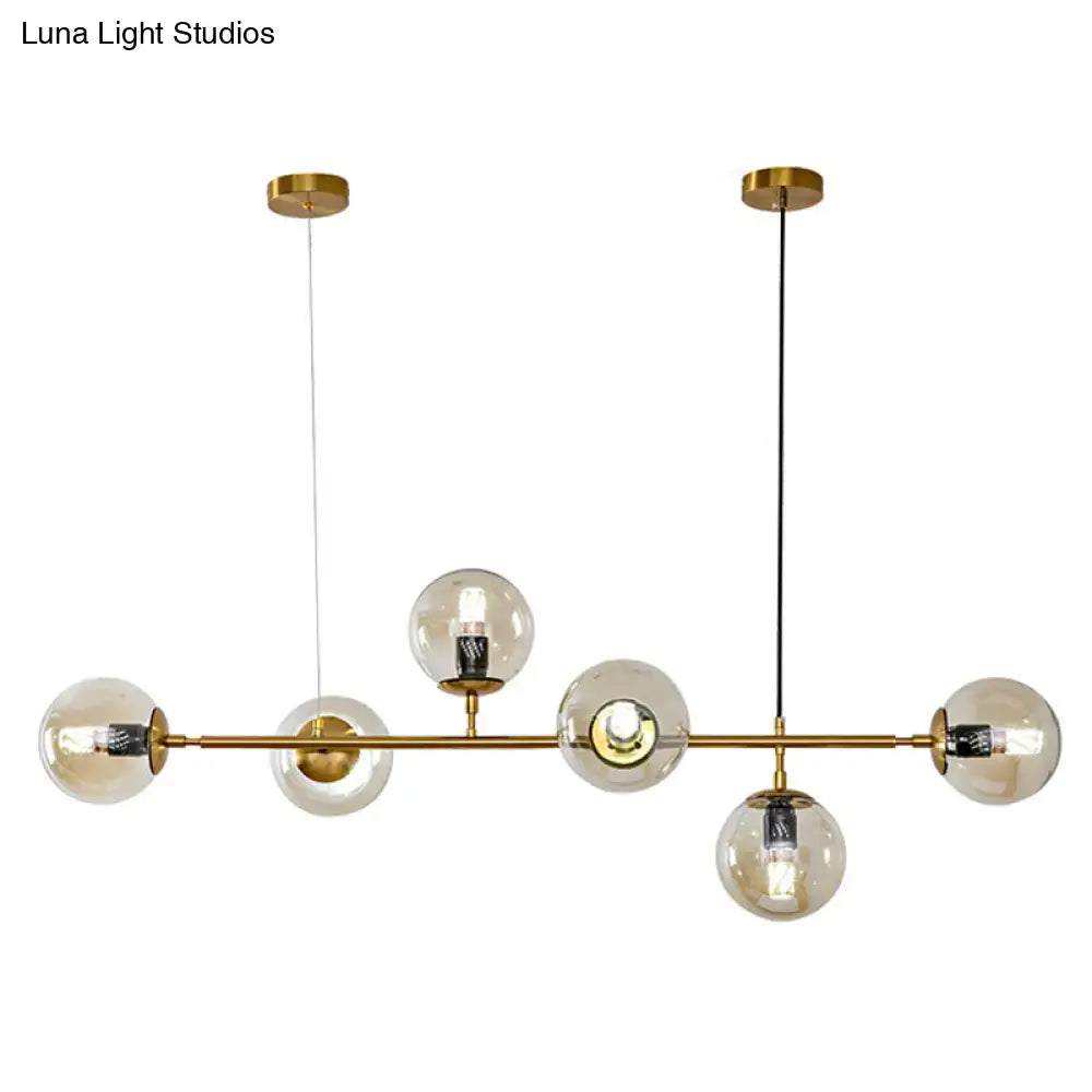 Modern gold island pendant light with glass globes for dining room