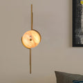 Modern gold marble led wall light featuring a gold-toned light fixture with a circular warm marble shade for bedroom use
