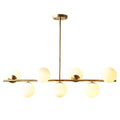 Modern gold metal island pendant dining room chandelier with six frosted white glass globe shades in linear design