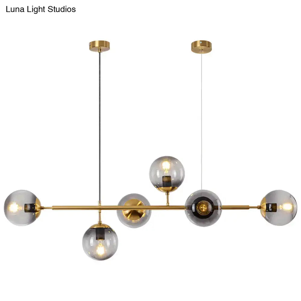 Modern gold metal island pendant with blue glass spheres dining room