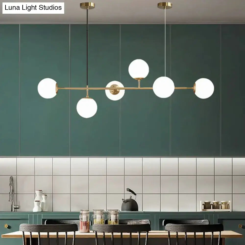Modern gold metal island pendant with blue glass spheres dining room