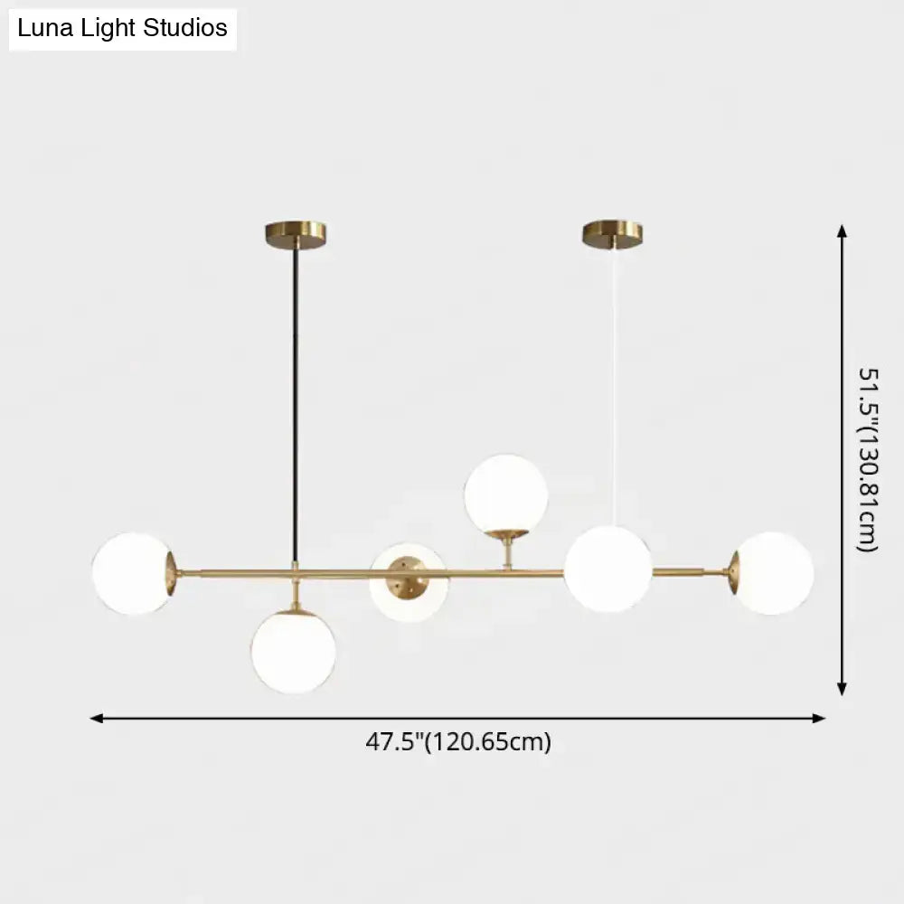 Modern gold metal island pendant with blue glass spheres dining room