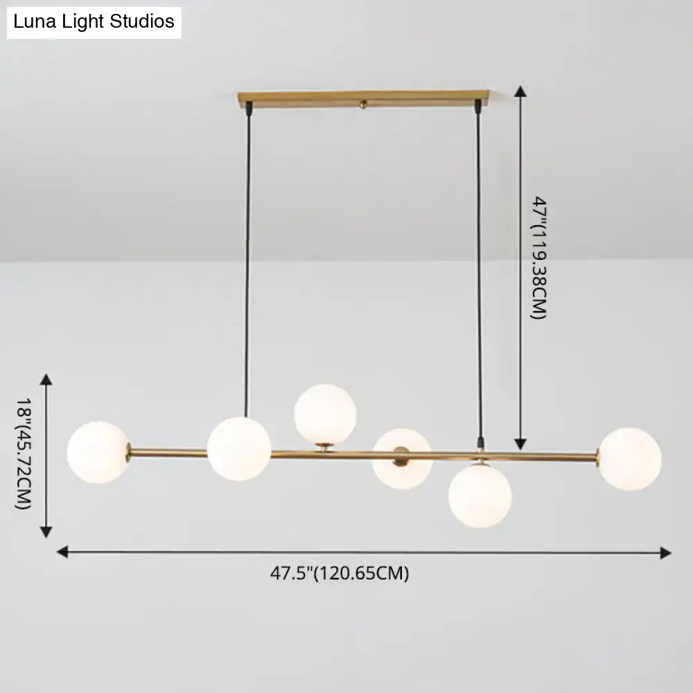 Modern gold metal island pendant with blue glass spheres dining room
