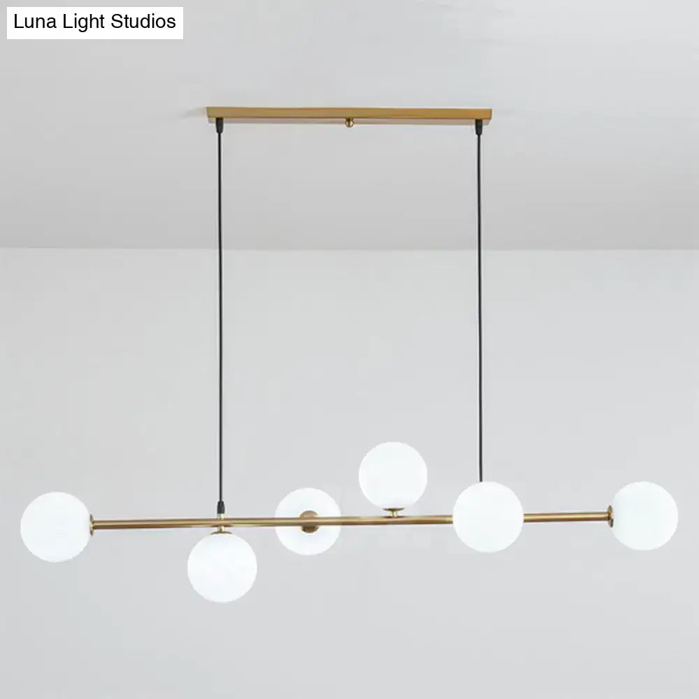 Modern gold metal island pendant with blue glass spheres dining room