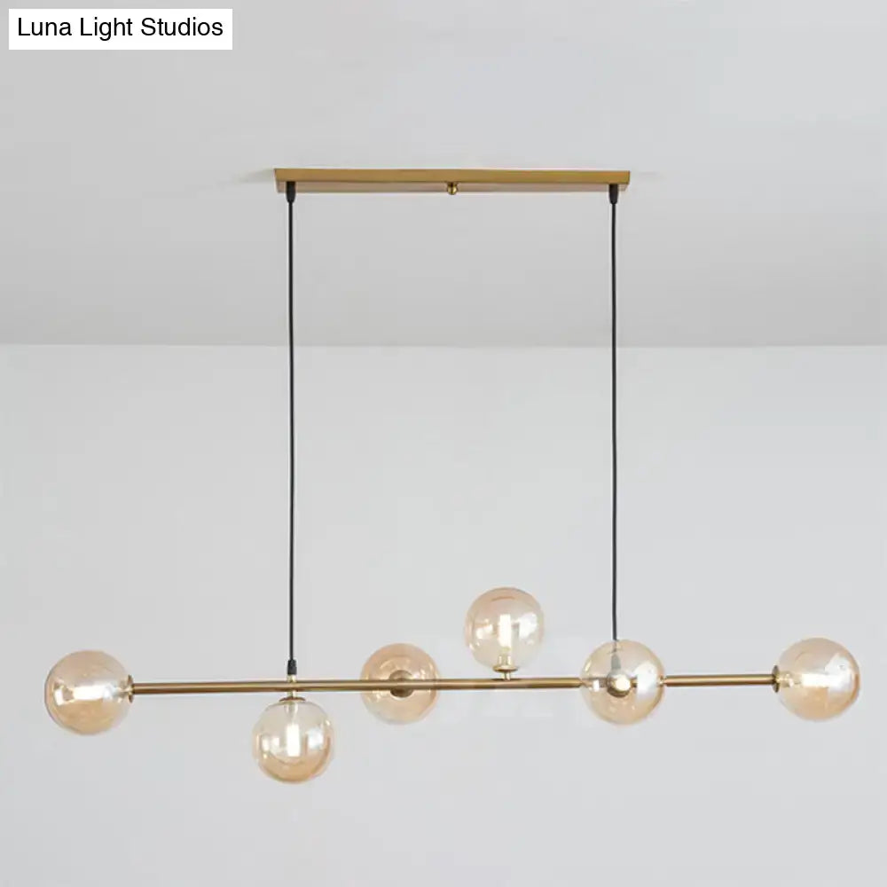 Modern gold metal island pendant with blue glass spheres dining room