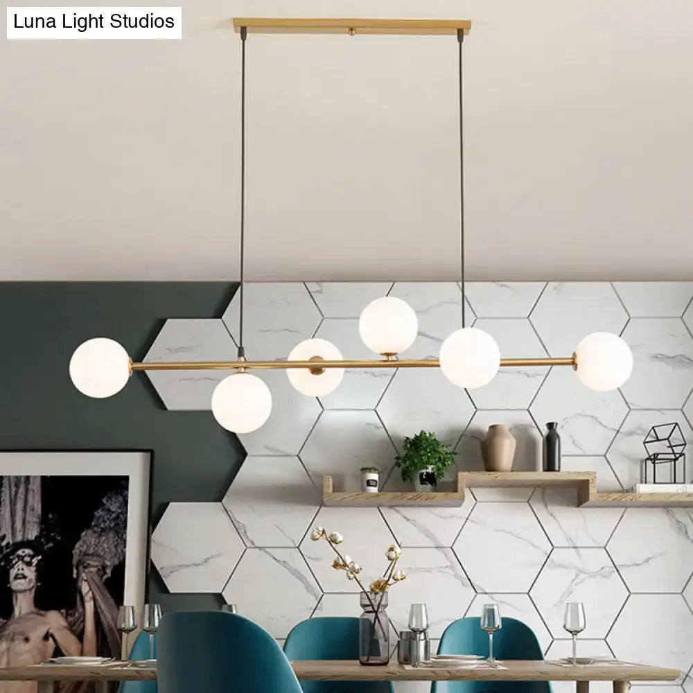 Modern gold metal island pendant with blue glass spheres dining room