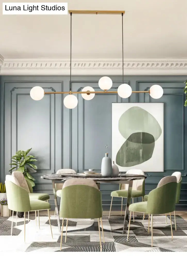 Modern gold metal island pendant with blue glass spheres dining room