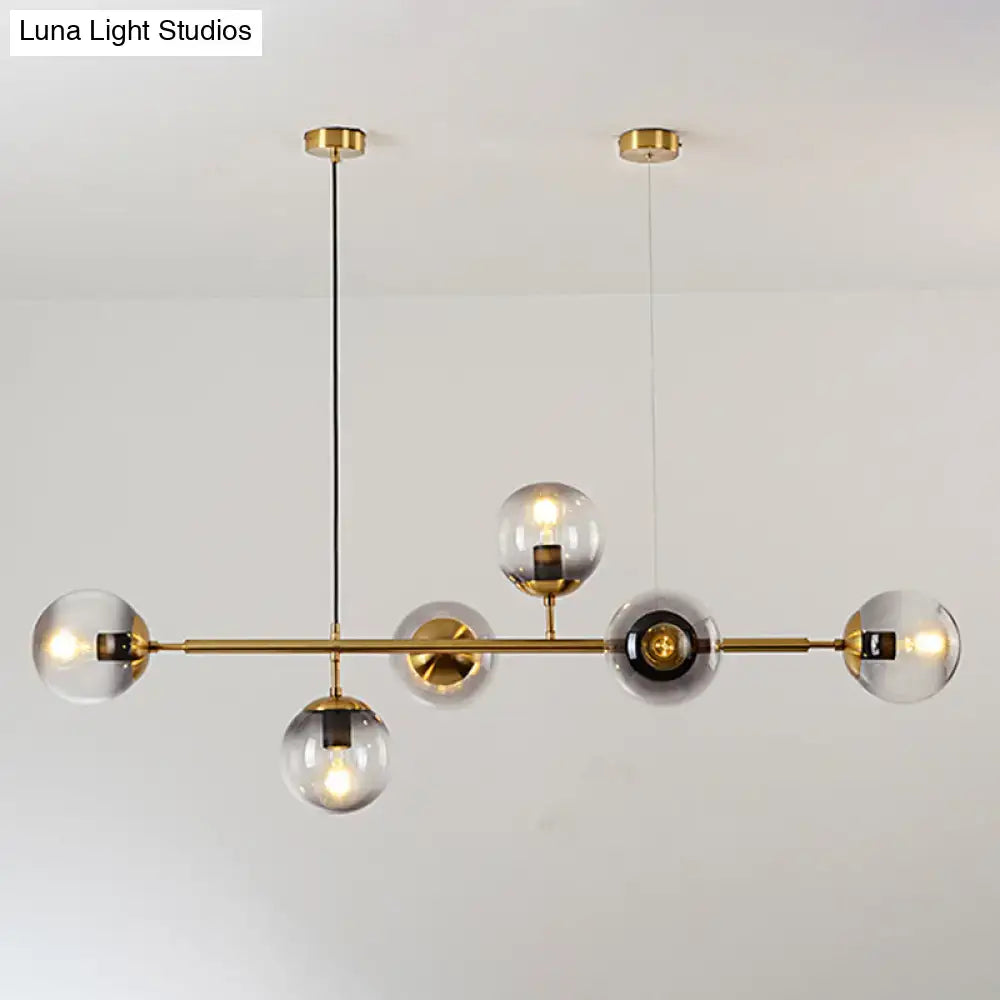 Modern gold metal island pendant with blue glass spheres dining room