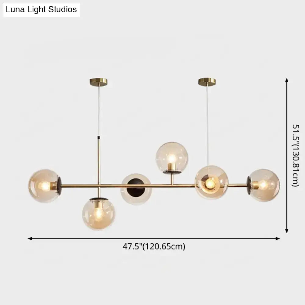 Modern gold metal island pendant with blue glass spheres dining room