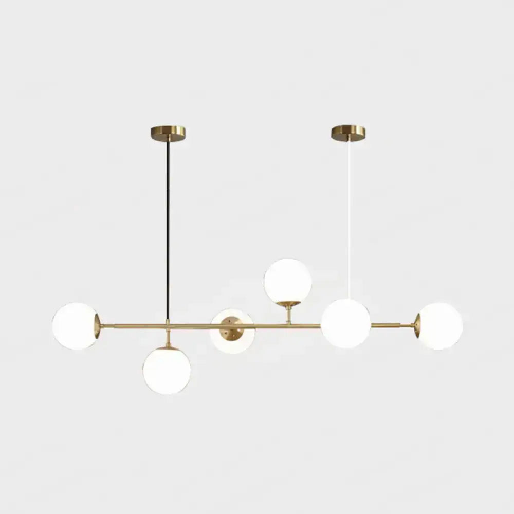 Modern gold metal island pendant with blue glass spheres dining room
