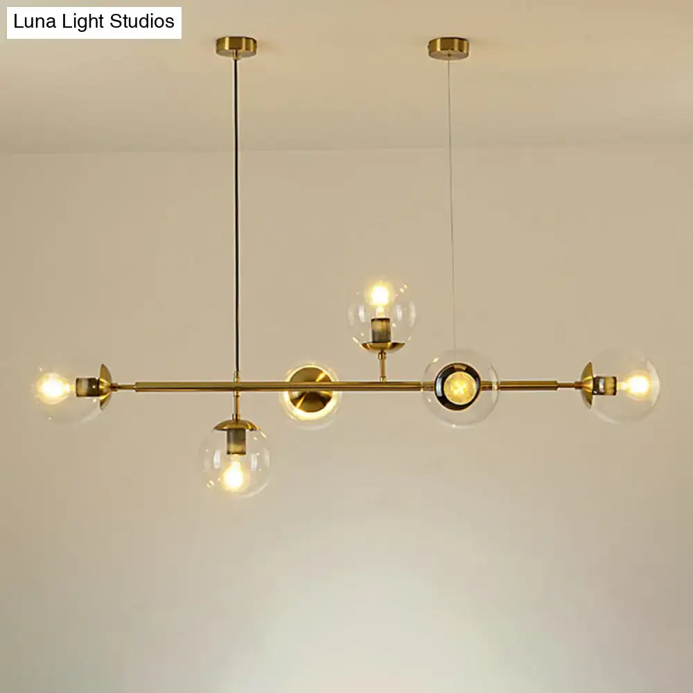 Modern gold metal island pendant with blue glass spheres dining room