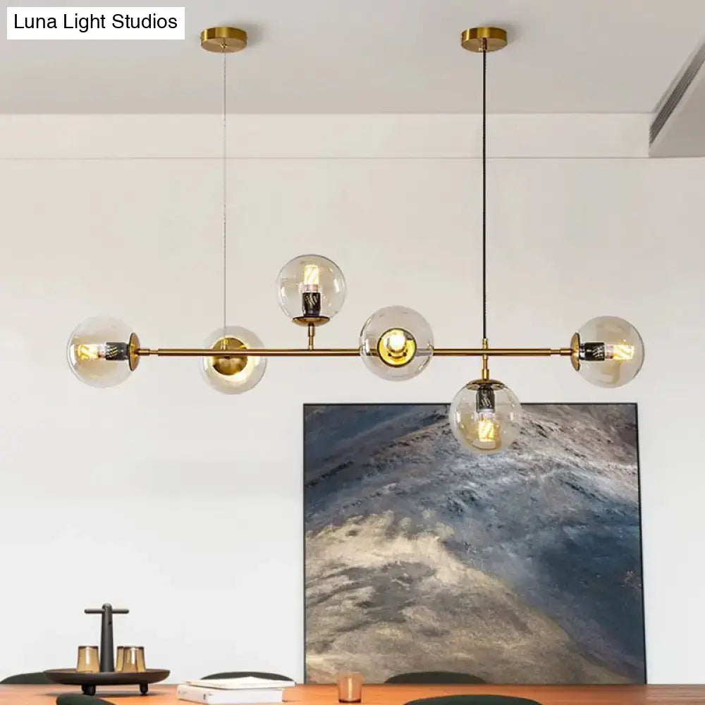 Modern gold metal island pendant with blue glass spheres dining room