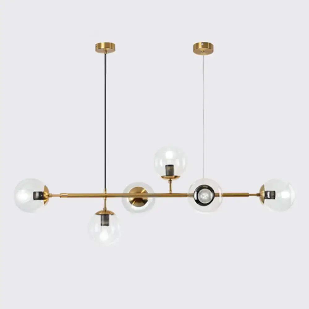 Modern gold metal island pendant with blue glass spheres dining room