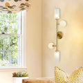 Modern gold metal pencil arm wall lamp with three frosted glass shades for bedroom lighting with metal pencil arm design