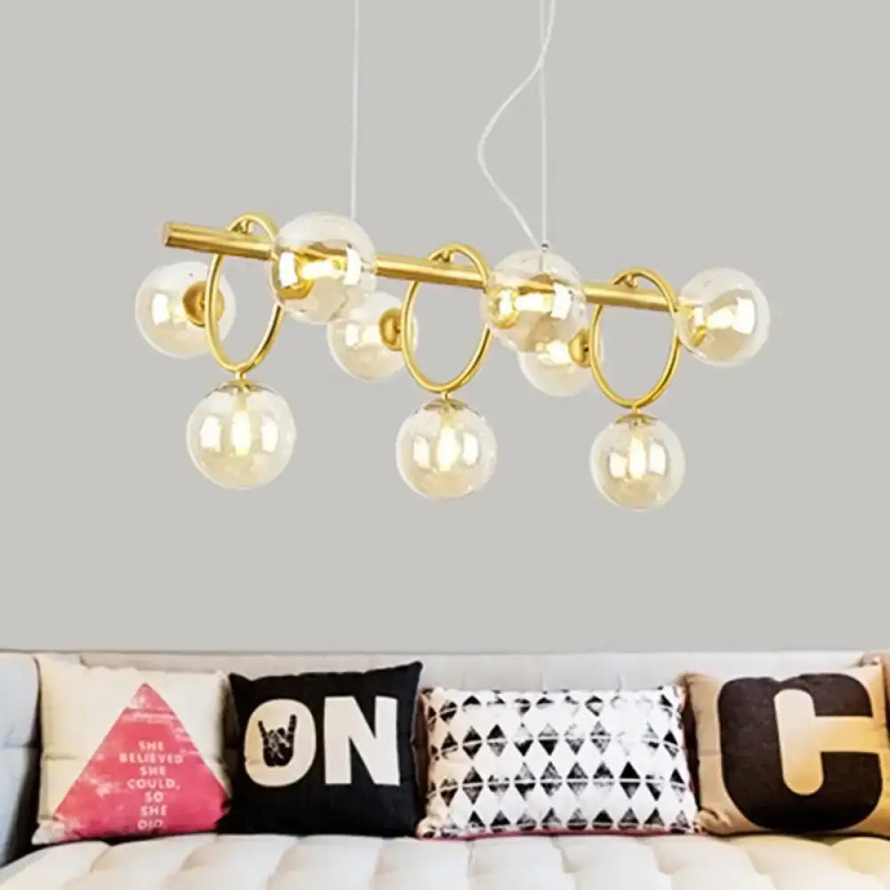 Modern gold pendant light with clear cognac glass for dining room