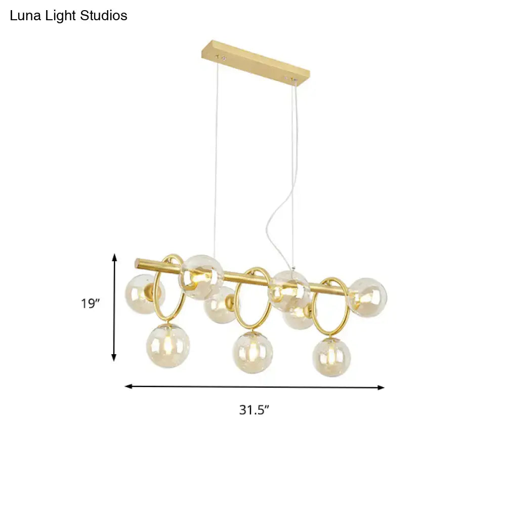 Modern gold pendant light with clear cognac glass for dining room