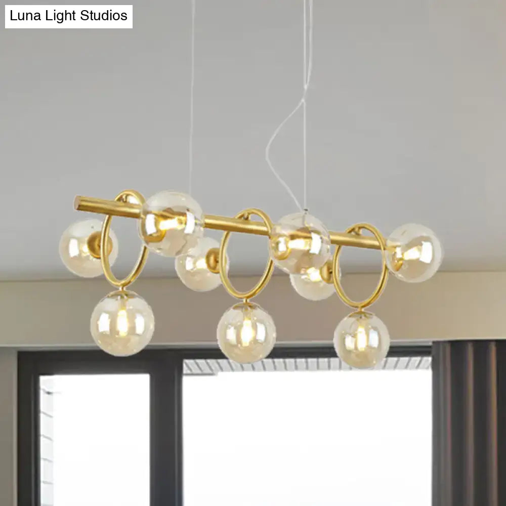 Modern gold pendant light with clear cognac glass for dining room