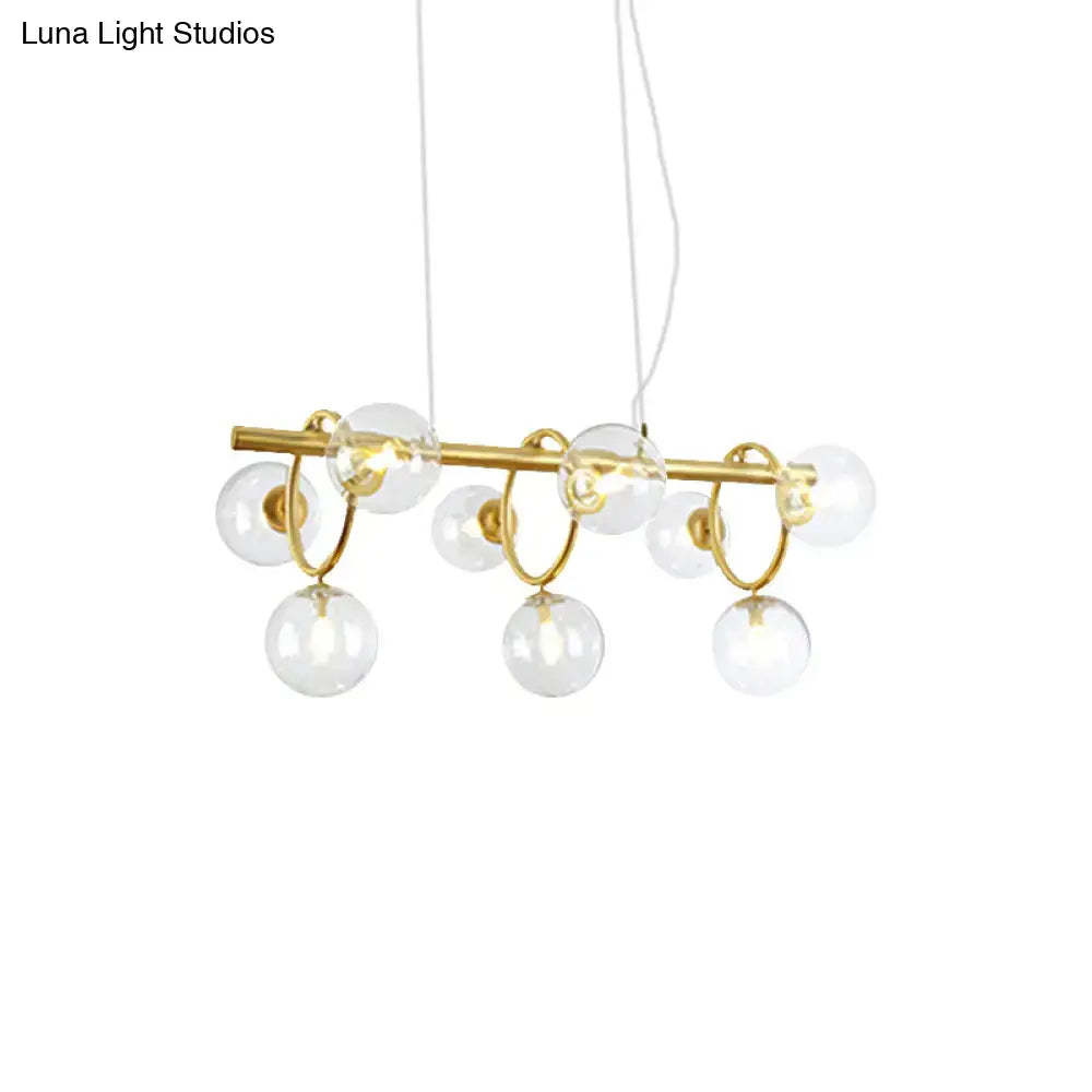 Modern gold pendant light with clear cognac glass for dining room