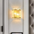 Modern gold ribbed glass living room wall mount light with vertical crystal rods and warm glowing light