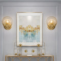 Modern gold ripple glass wall light fixture featuring gold-toned concentric circles for living room use