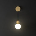 Modern gold sconce light wall lamp featuring a gold-toned spherical pendant with milky glass and minimalist fixture