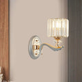 Elegant modern gold wall light with clear crystal shade featuring vertical prisms and decorative backplate for living room