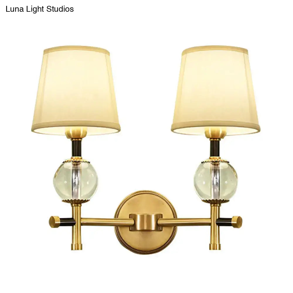 Modern gold wall light with crystal and fabric shade bedroom
