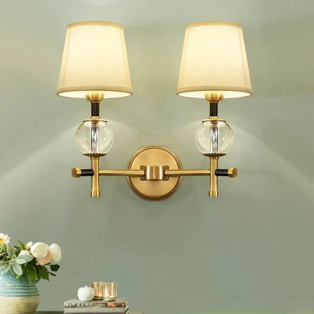 Modern gold wall light with crystal and fabric shade bedroom