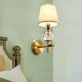 Modern gold wall light with crystal and fabric shade bedroom